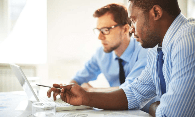 two people working at a laptop